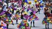 Personas con papel picado como vestidos y máscaras de calavera.jpg