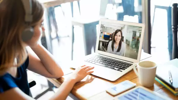 Una mujer observa la pantalla de su computadora durante una junta a distancia. Tata Consultancy Services, teletrabajo, tendencias, Tecnología de la Información