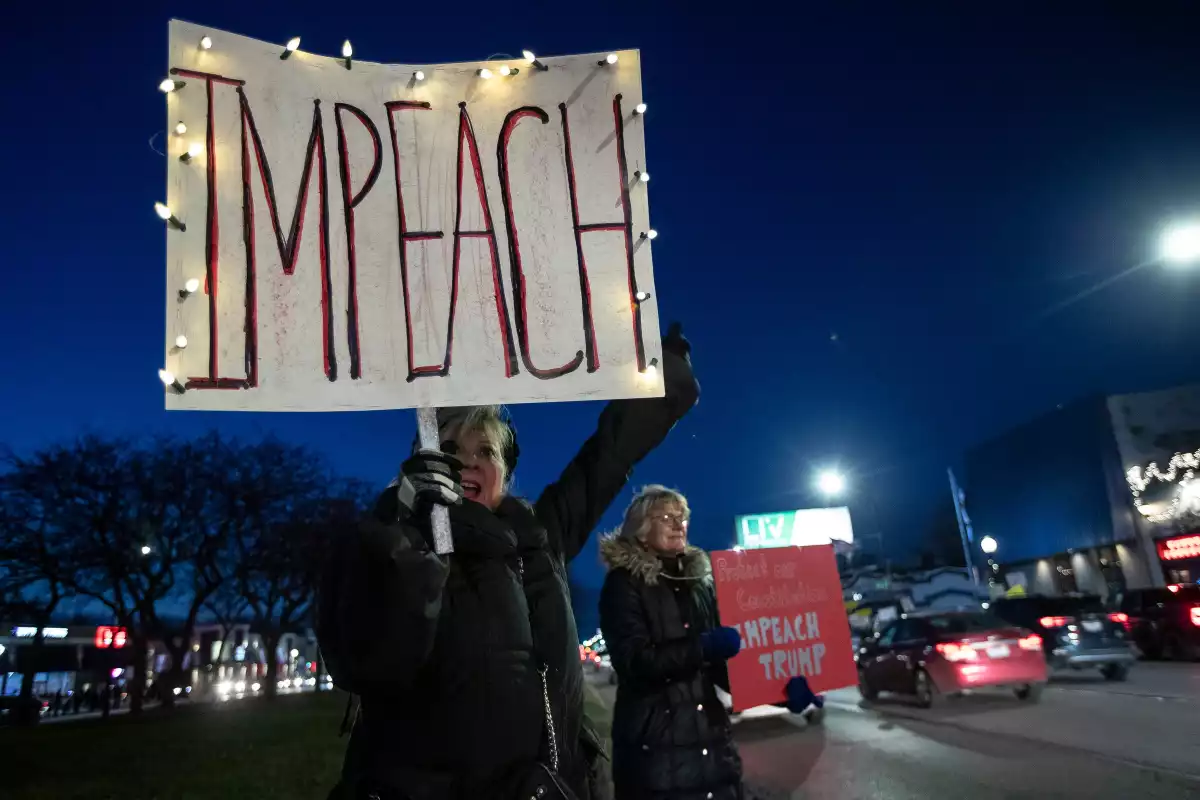 Jane Wienner of Lake Orion, left, and Barbara Harlow of Livonia chant \"This is what democracy looks like\" at incoming traffic
