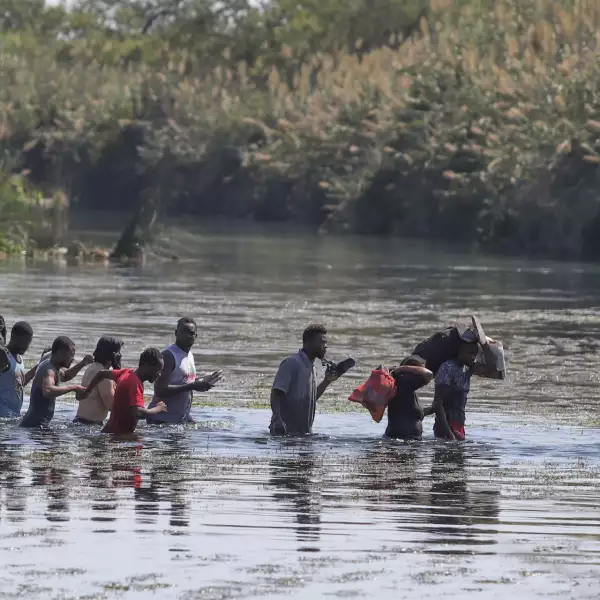 Haitianos cruzan el río Bravo del lado texano hacia suelo mexicano para conseguir comida y víveres. Los migrantes permanecen desde hace varios días en un campamento instalado de lado estadounidense en espera de que aquella nación les brinde asilo político.
