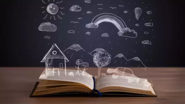 Open book with hand drawn landscape