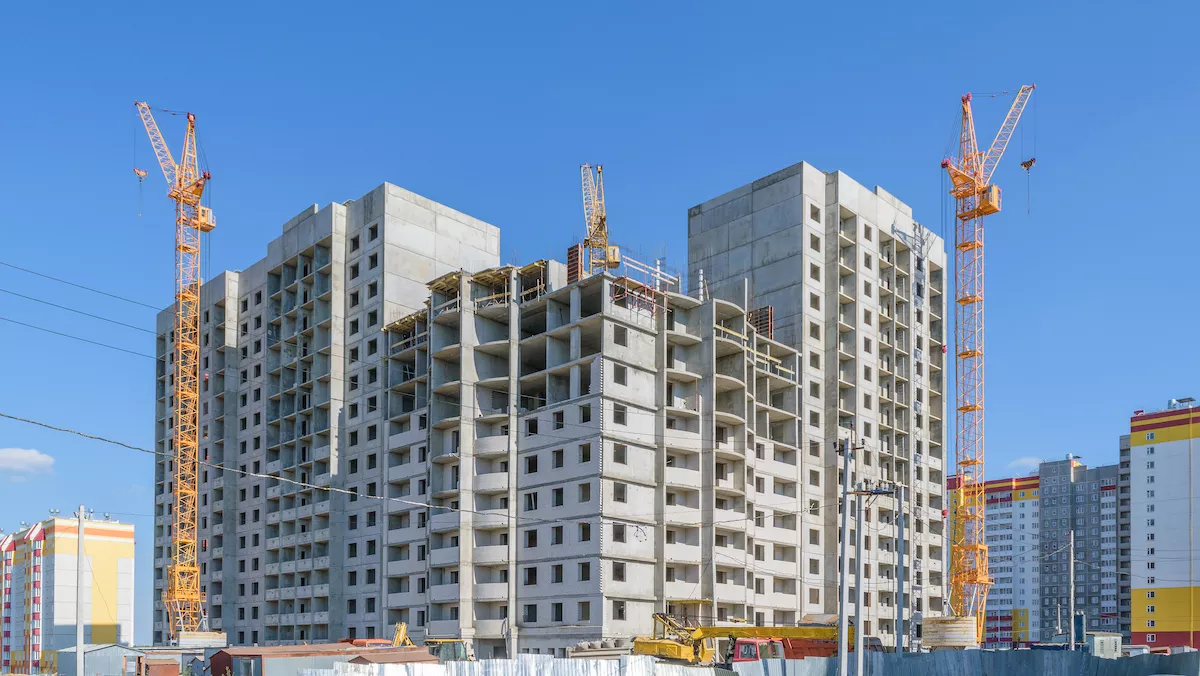 Construction of new multi-storey panel house. Three tower cranes