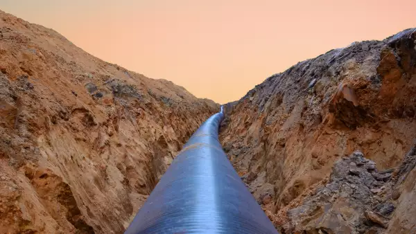 Constructing pipelines that transport oil, natural gas, petroleum and crude production. A dug trench in the ground for the installation of industrial gas and crude pipes