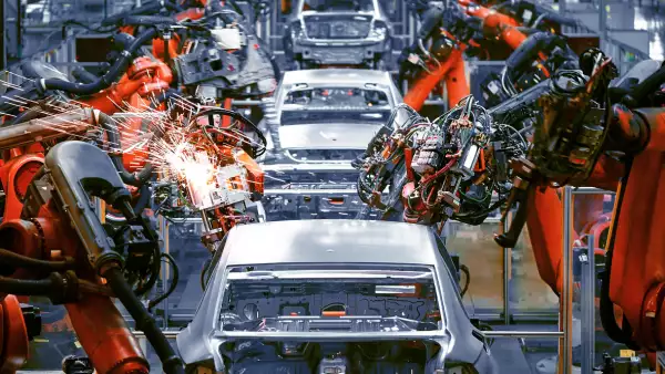 In the industrial production workshop, the robot arm of the automobile production line is working