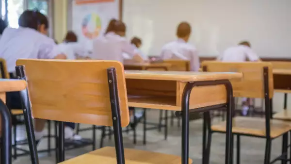 Lecture room or School empty classroom with Student taking exams, writing examination for studying lessons in high school thailand, interior of secondary education, whiteboard. educational concept