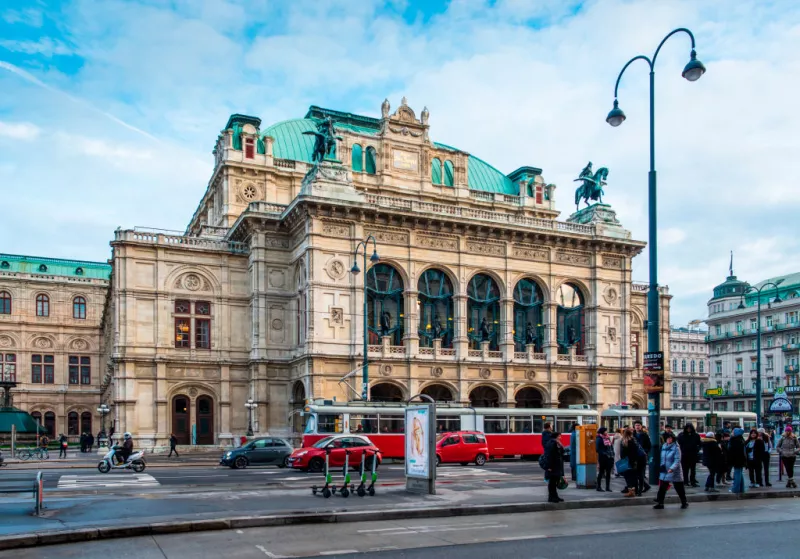 trams pass the State Opera House on Ringstrasse, Vienna, Austria