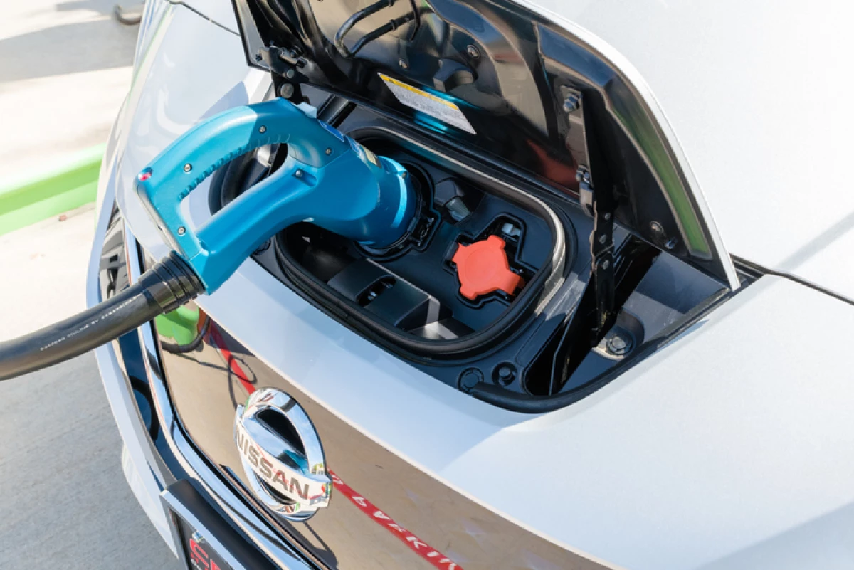 New 2018 Nissan Leaf electric car plugged in to charge battery at the EVgo charging station