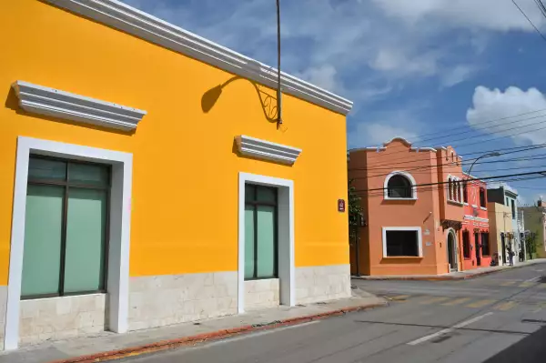 Colorful colonial style buildings at street of Merida city