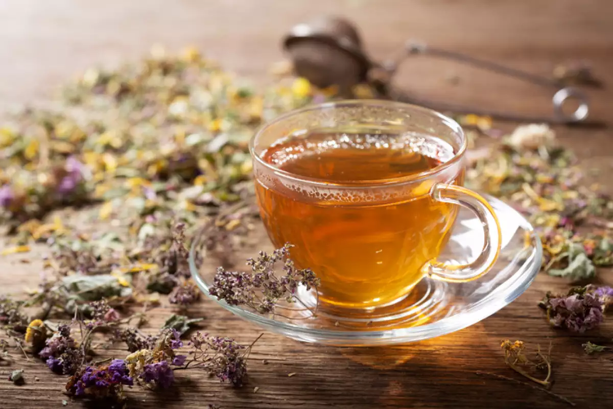 Cup of herbal tea with various herbs