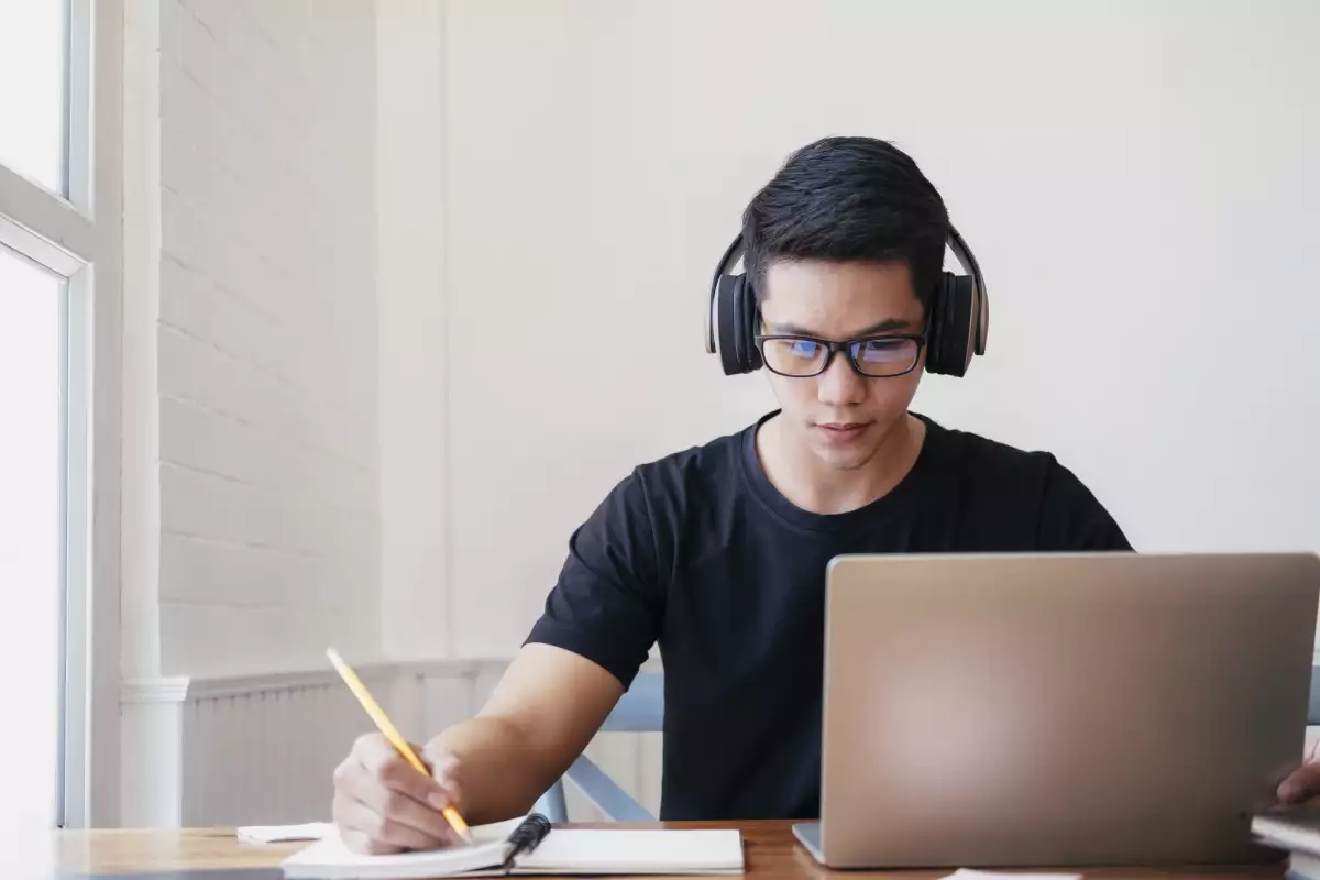 Young man student study at home using laptop and learning online.