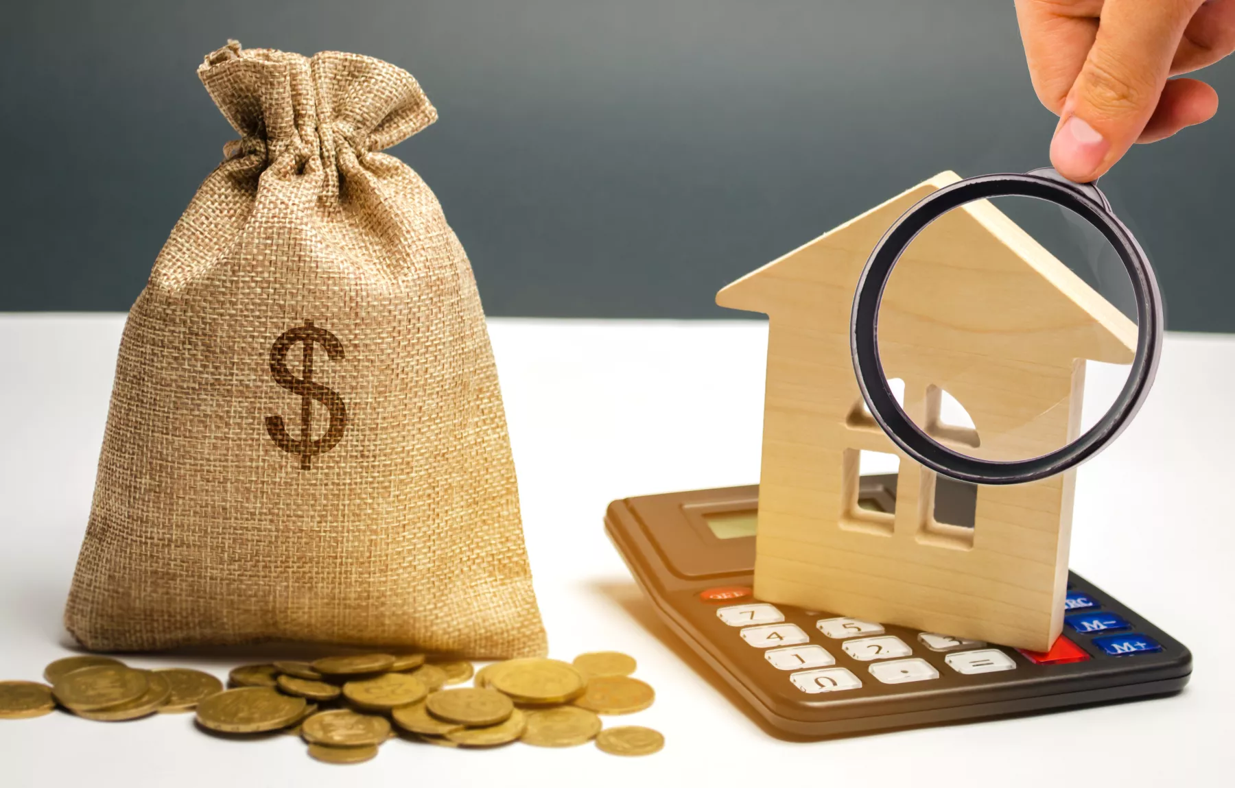 Bag with money and dollar sign and wooden houses. Financing in the country. Investing money in real estate. Saving and accumulation of money. Mortgage. Buying a home. Property sale. City budget.
