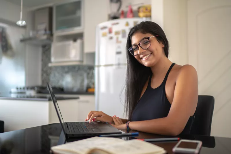 Young woman using laptop at home