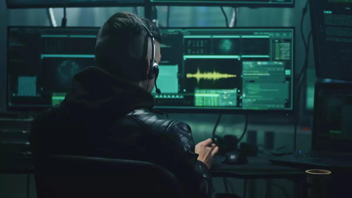 Happy hacker discussing successful cybercrime