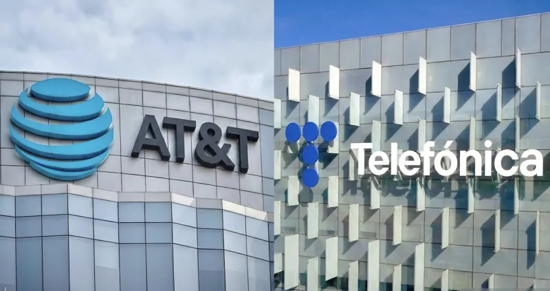 Dos edificios grises en donde uno tiene el logo de AT&T y otro  de Telefónica. 