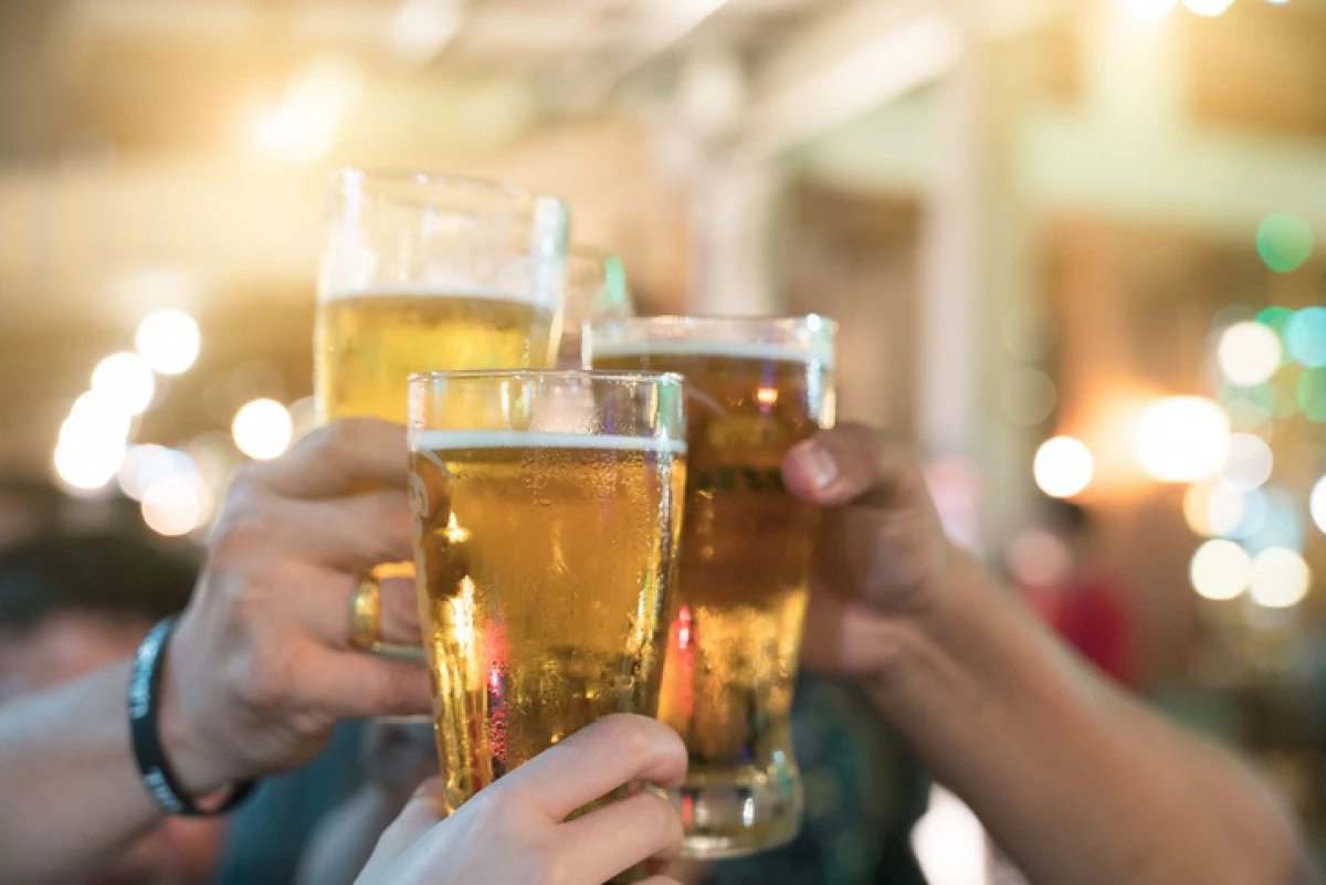 A group of friends with drinks at a nightclub. Young people are enjoying