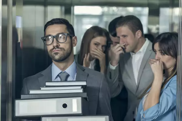 Smelly businessman affecting his coworkers in an elevator