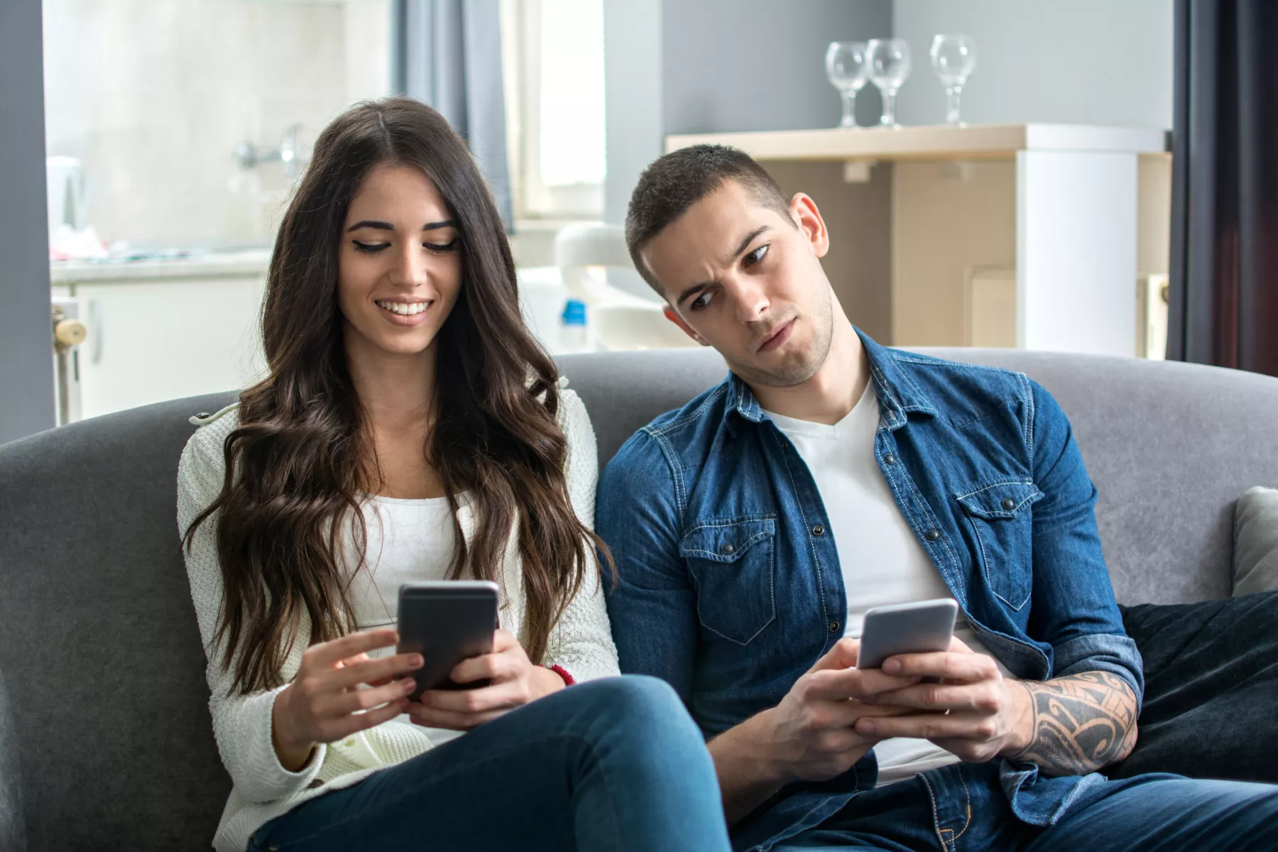 Jealous boyfriend spying his girlfriend's phone.