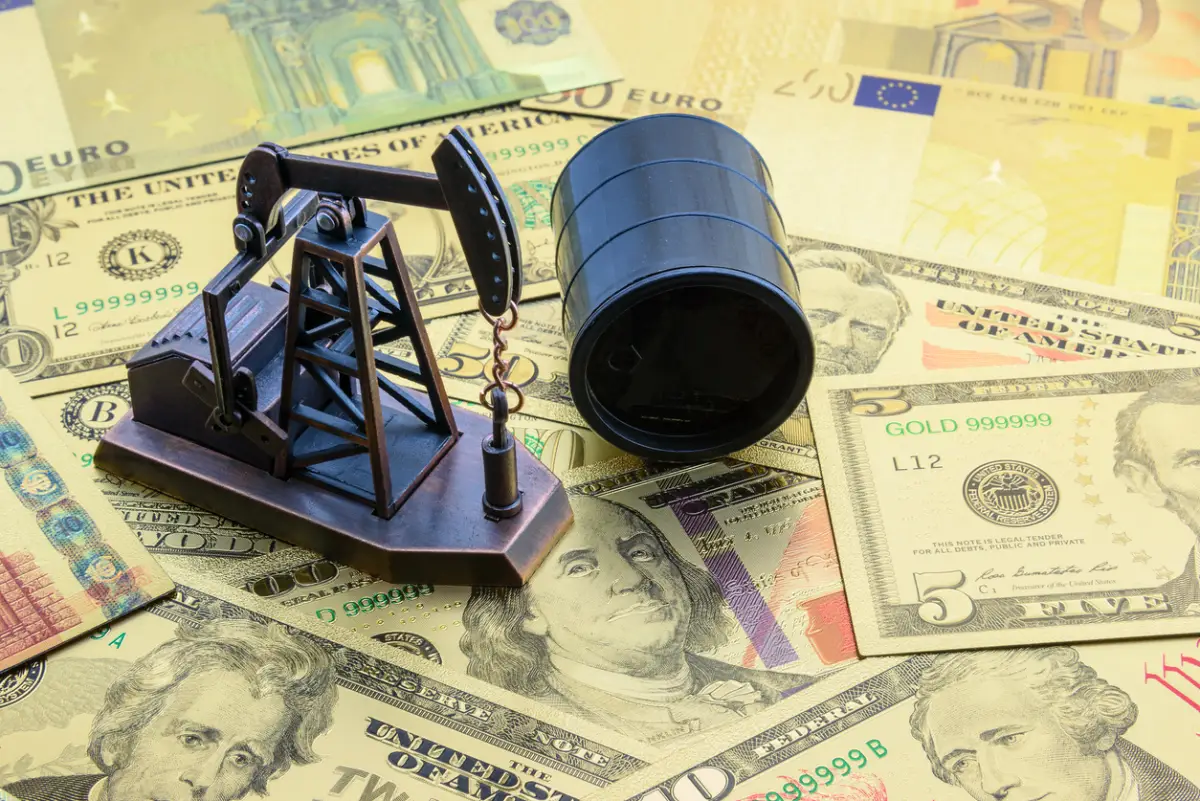 Petroleum, petrodollar and crude oil concept : Pump jack and a black barrel on US USD dollar notes, depicts the money received or earned from sales after investment in the development of oil industry.