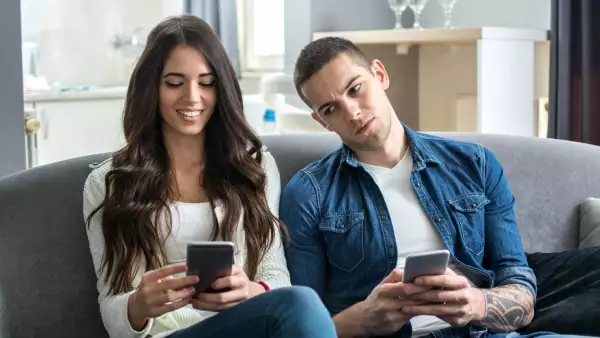 Jealous boyfriend spying his girlfriend's phone.