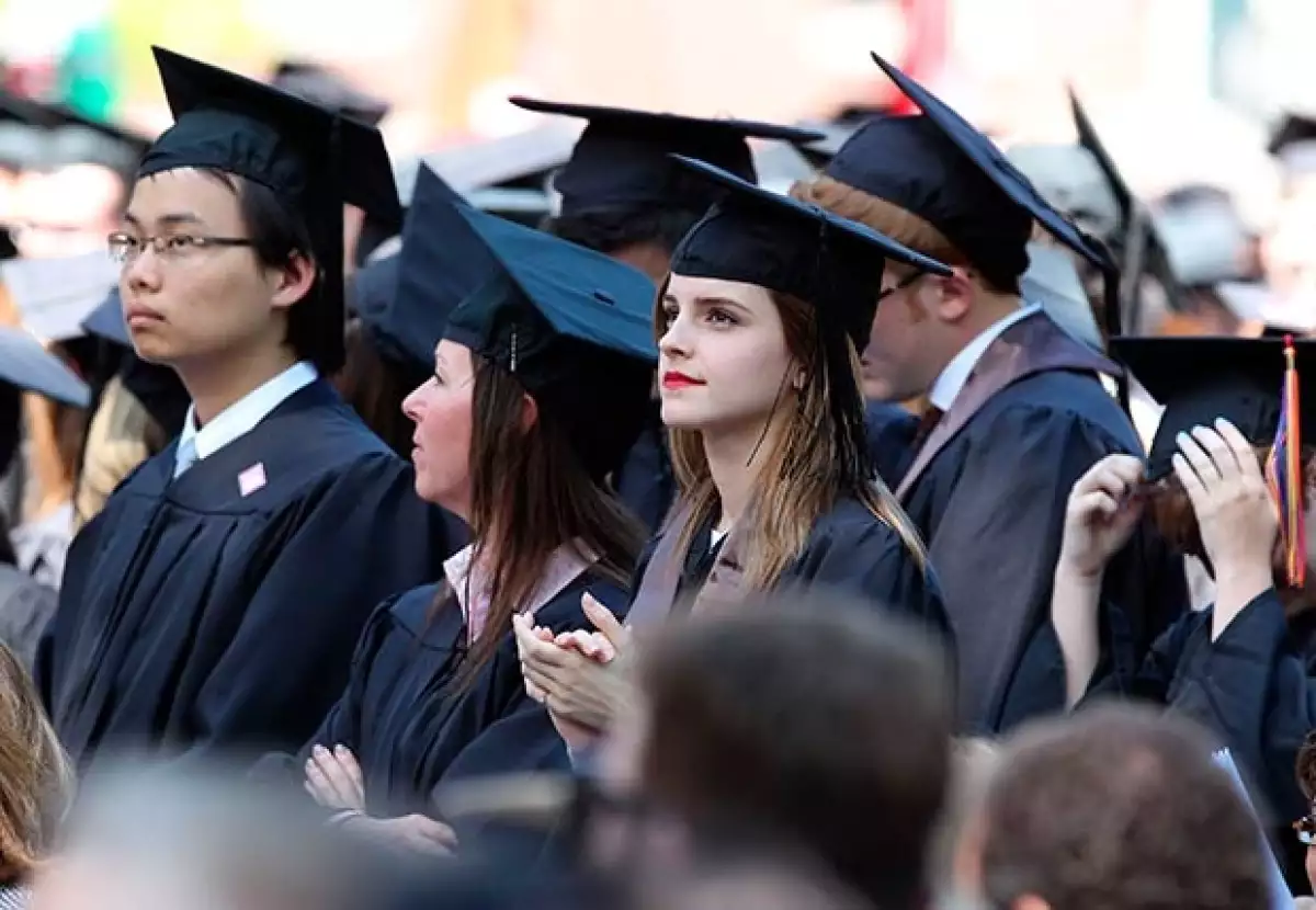La mujer que se aprecia al lado derecho de Emma es la misma mujer que la resguarda una vez culminado el evento universitario.
