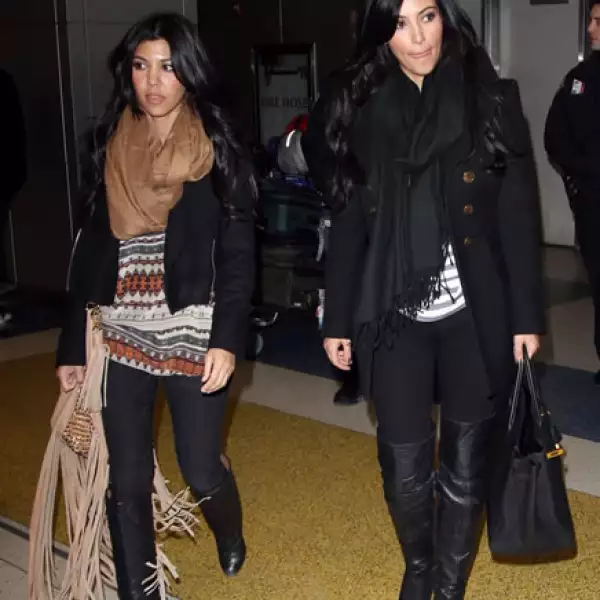 Kourtney Kardashian y Kim Kardashian regresaron de los Golden Globes realizados en Los Ángeles esta semana. Fueron vistas en el aeropuerto de Nueva York vistiendo muy similar: botas negras, playera holgada, foulard y chamarra negra.
