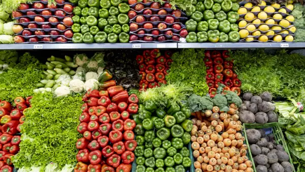 Delicious fresh vegetables and fruits at the refrigerated section of a supermarket