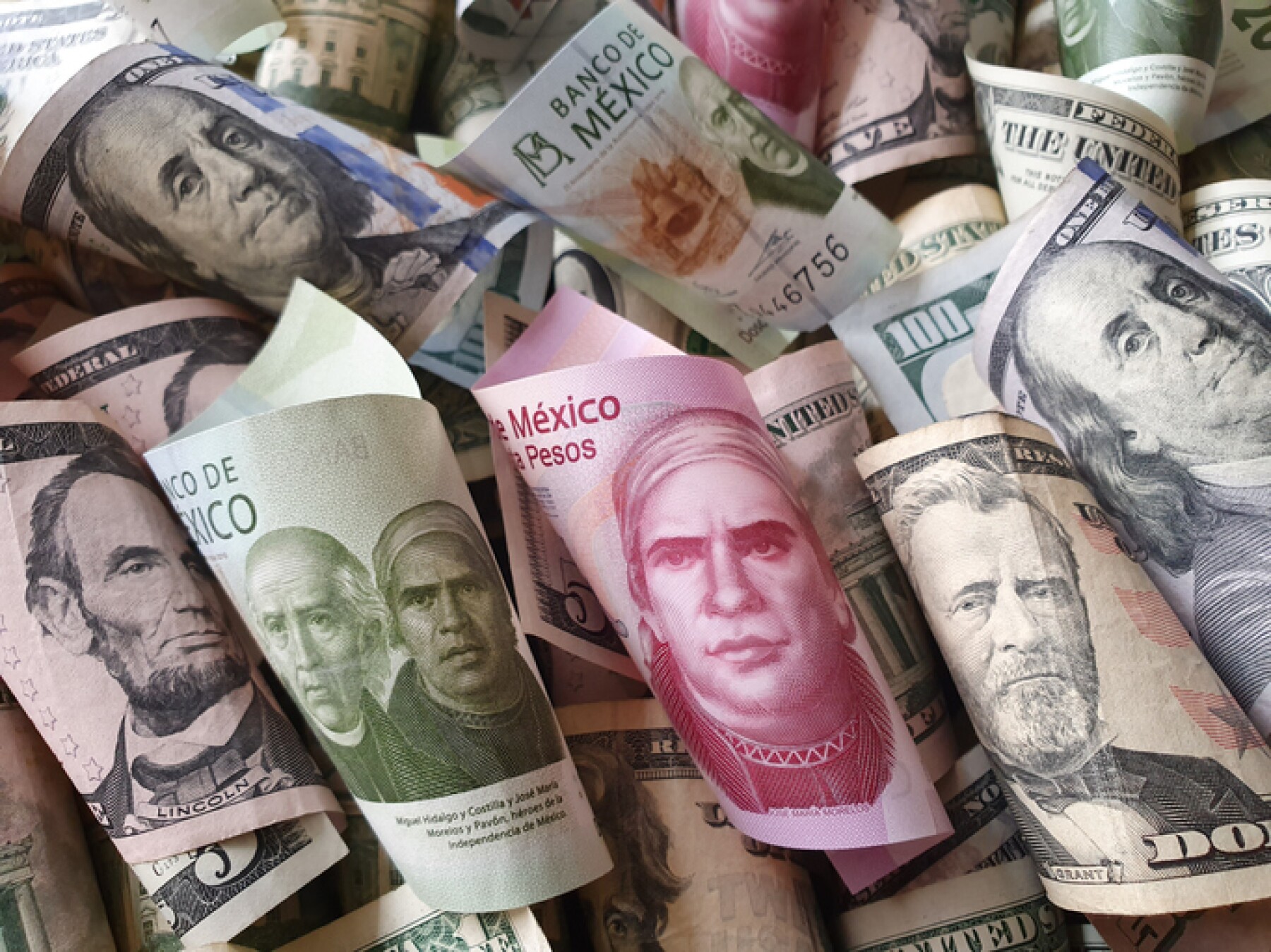american dollar banknotes and mexican bills of different denominations
