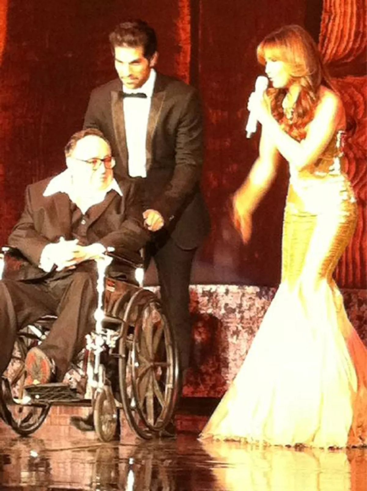 La cantante lució un vestido dorado largo.