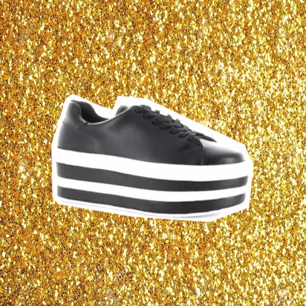 Sprinkle glitter gold dust on a black background with copy space