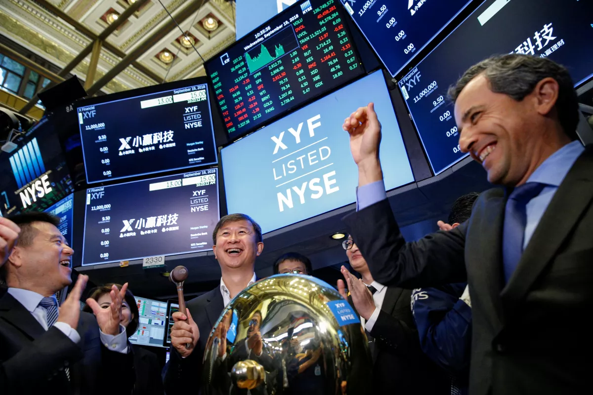 Shaoyong (Simon) Cheng, president of X Financial, a Chinese technology and personal finance company, rings a ceremonial bell to start trading the company's stock during the company's IPO at the NYSE in New York