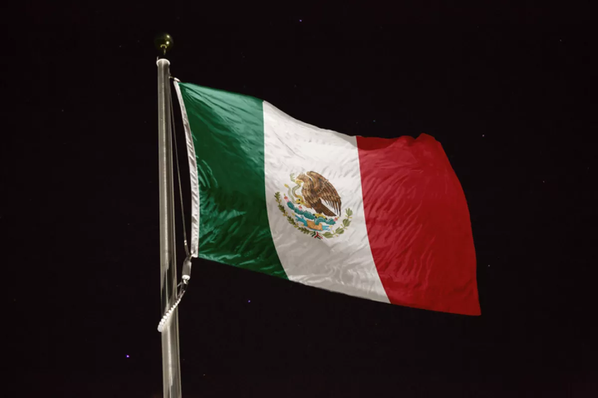 Mexico flag blowing in the wind at night