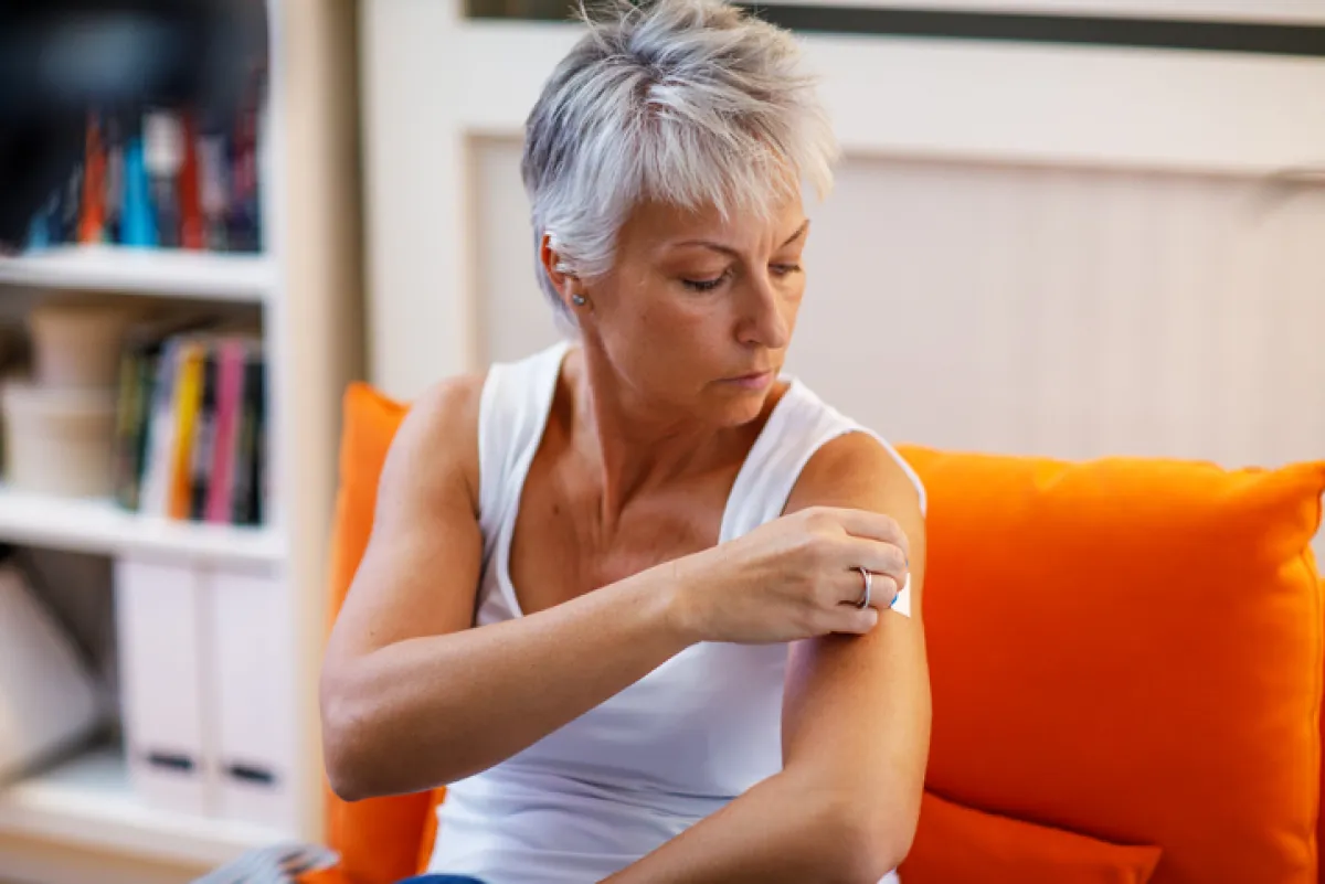 Mature Woman Applies Transdermal Patch
