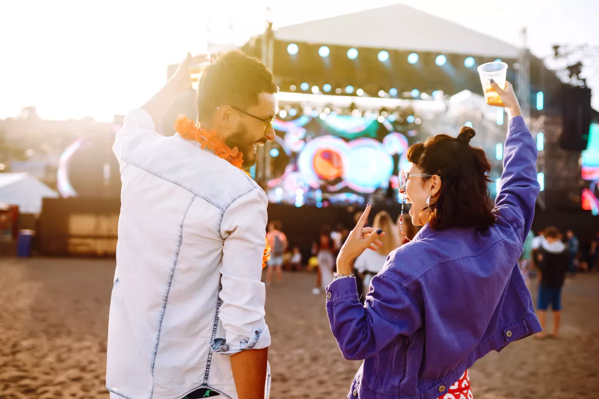 Couple with beer at music festival.