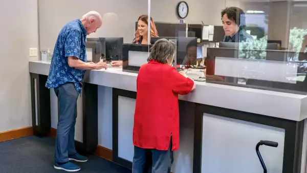 Senior man and woman at business reception desk