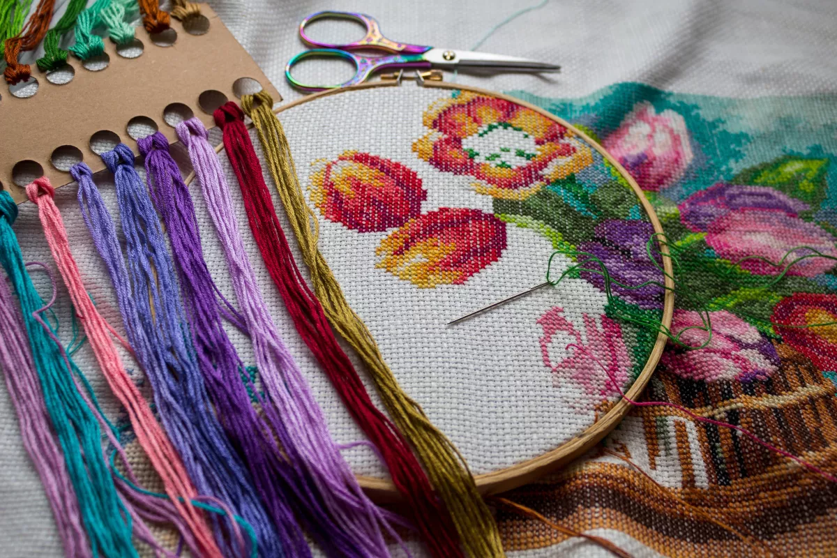 Flat,Lay,Of,An,Embroidery,Hoop,With,Colorful,Floral,Cross-stitch,
