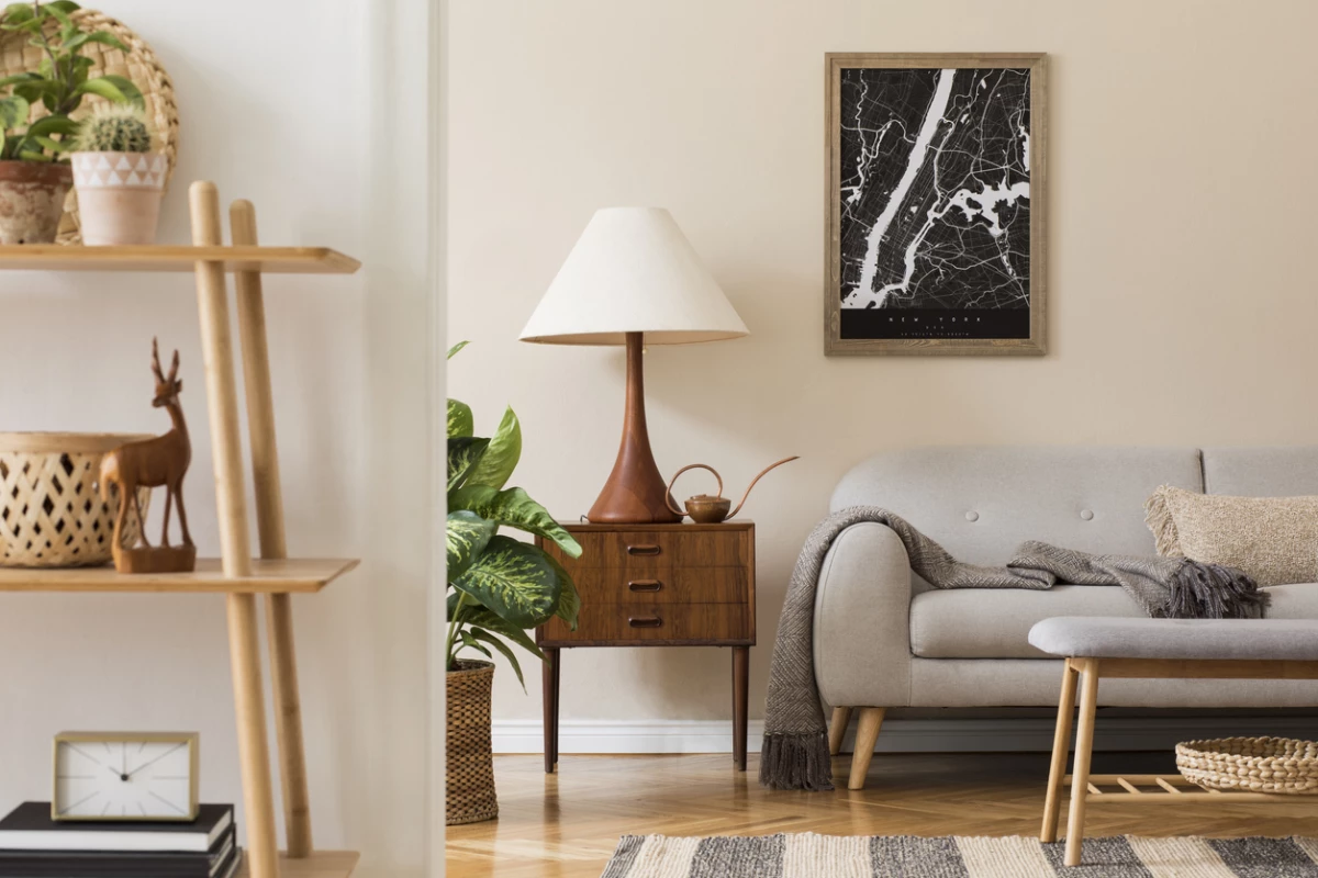 Modern composition of living room interior with brown mock up poster frame, design retro commode, sofa, bookstand, rattan basket with plant and elegant accessories. Template. Stylish home staging.
