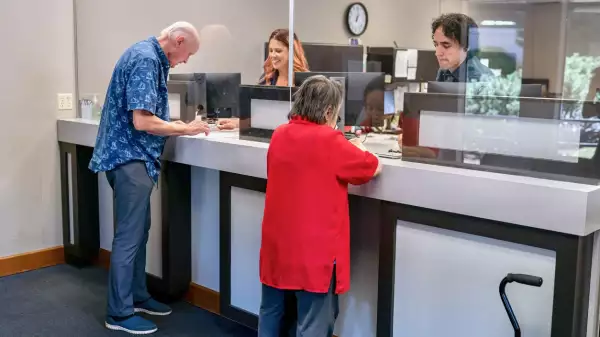 Senior man and woman at business reception desk