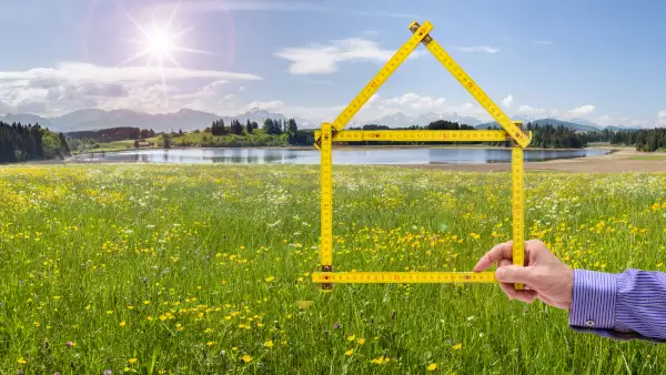 model house made with folded yardstick in beautiful landscape
