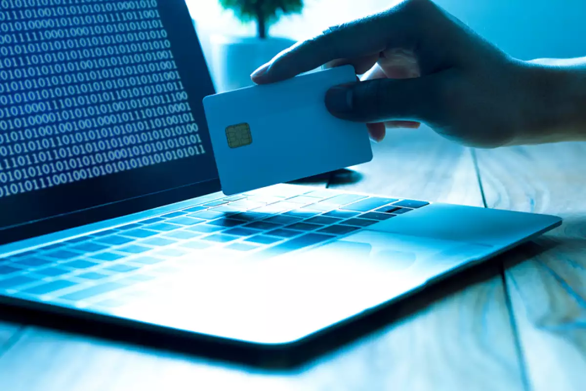 The concept of credit card theft. Hackers with credit cards on laptops use these data for unauthorized shopping. Unauthorized payments from credit card owners. In the hacker's secret office