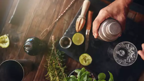 Barman preparing cocktail in shaker