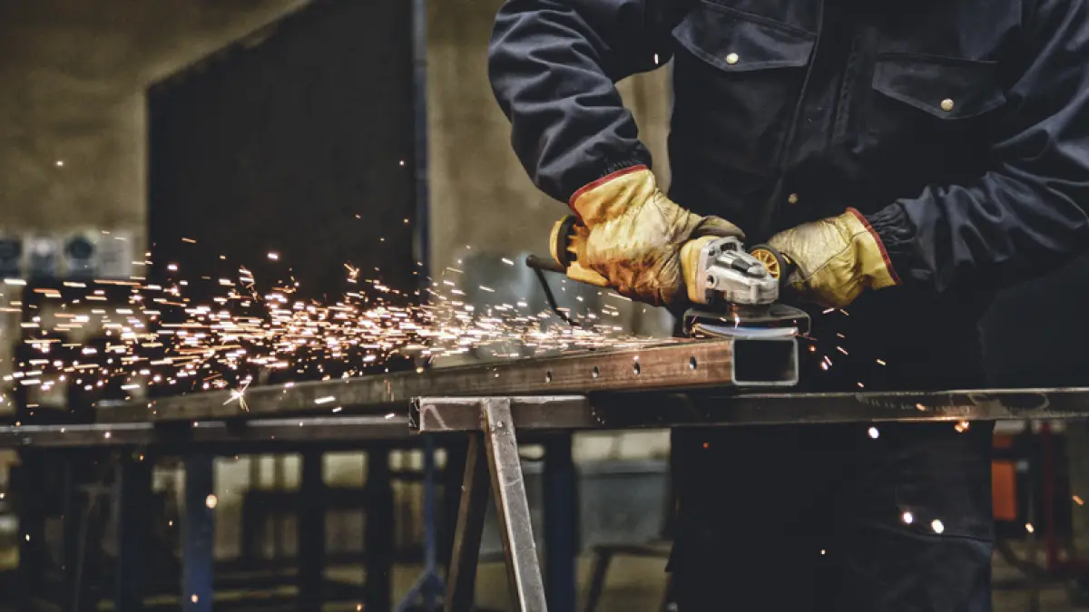 Worker with the grinder