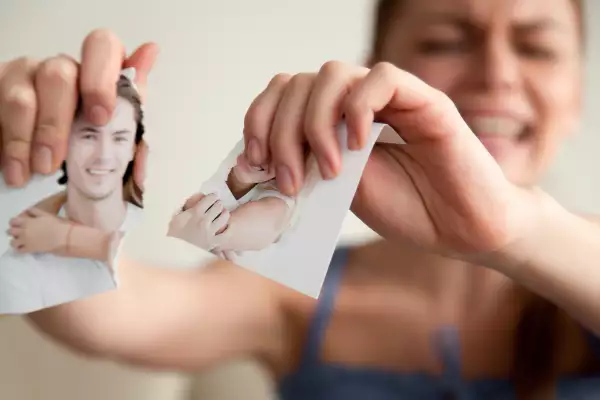 Offended woman tears photo with her boyfriend