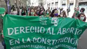 Mujeres sostienen una pancarta que dice "Derecho al aborto en la Constitución" durante una demostración afuera del antiguo Congreso Naciones, en Santiago de Chile. 
