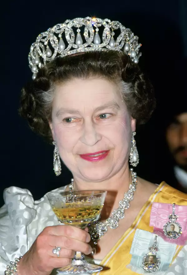 Queen Elizabeth II drinks champagne at a State Banquet in Ne