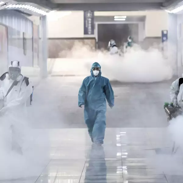 Volunteers in protective suits disinfect a railway station as the country is hit by an outbreak of the new coronavirus, in Changsha
