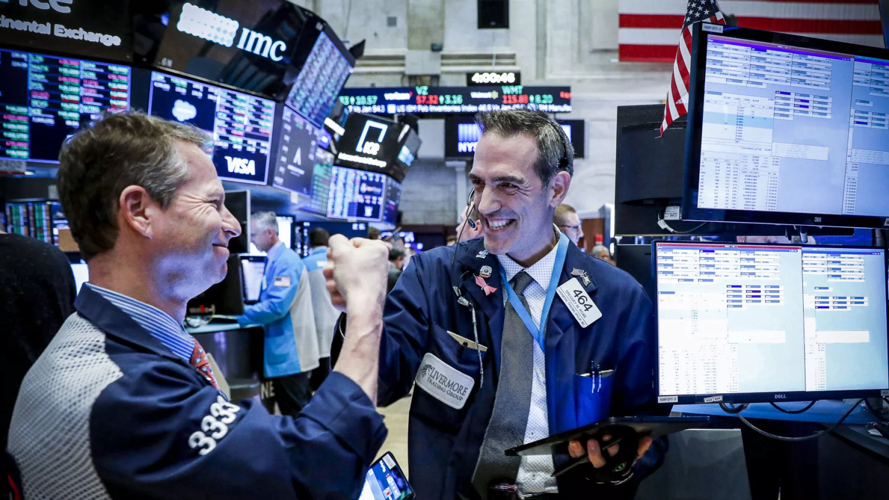 Traders celebrate as they work on the floor at the NYSE in New York