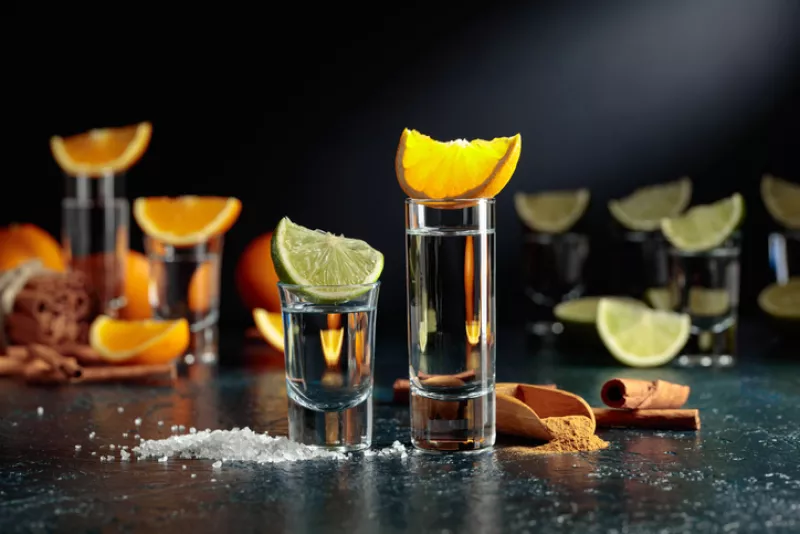 Tequila shots on a black background.