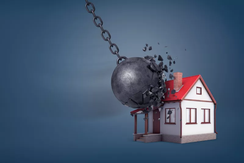3d rendering of a giant wrecking ball breaks in small pieces when hits a small family house