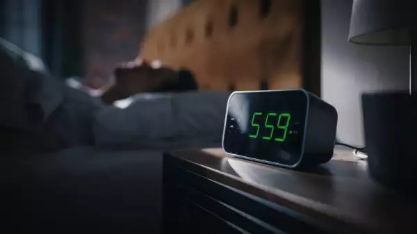 Man Wakes Up and Turns off Alarm Clock at 5 am.