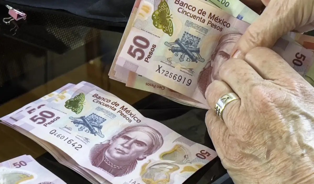 Senior woman counting money, Mexican pesos
